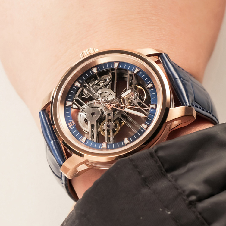 On-wrist view of the 9015 skeletonized mechanical watch in rose gold and blue